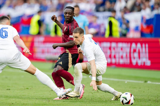 Jeremy Doku of Belgium and Peter Pekarik of Slovakia