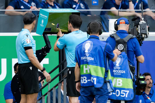 Referee Umut Meler with a VAR review