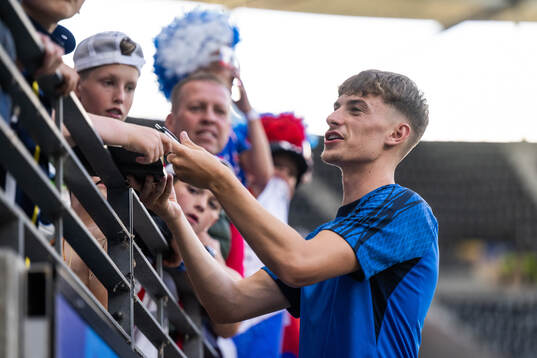 Tomas Rigo of Slovakia signs autographs