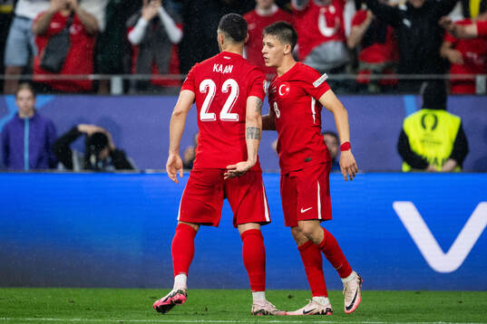 Arda Guler of Türkiye celebrates with Kaan Ayhan