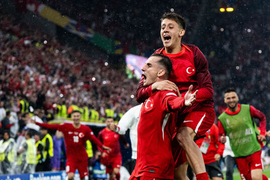Kerem Akturkoglu of Türkiye celebrates with Arda Guler