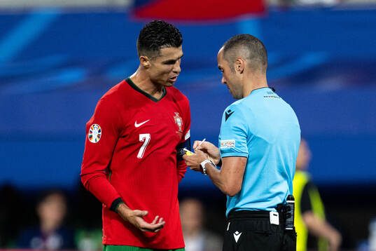 Cristiano Ronaldo of Portugal in discussion with referee