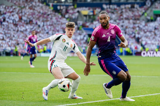 Milos Kerkez of Hungary and Jonathan Tah of Germany