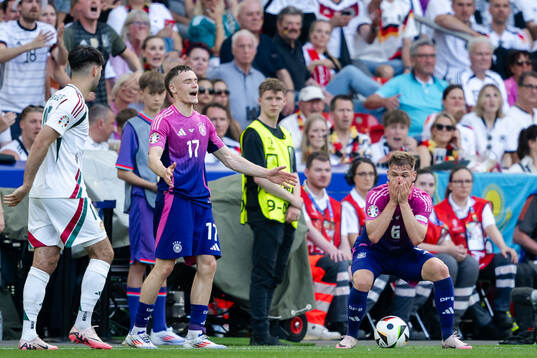 Florian Wirtz and Joshua Kimmich of Germany react