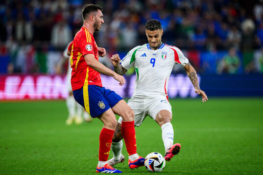 Aymeric Laporte of Spain and Gianluca Scamacca of Italy