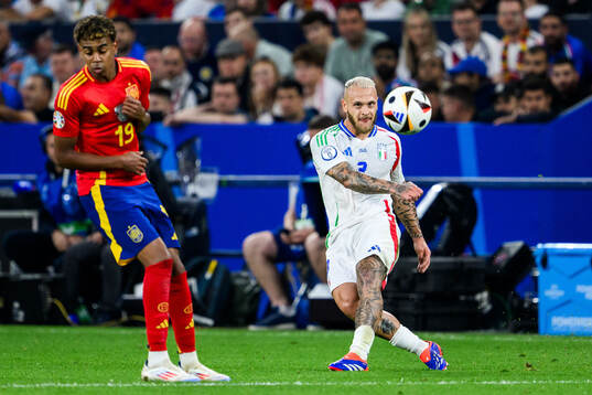 Lamine Yamal of Spain and Federico Dimarco of Italy