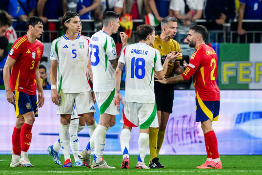 Alessandro Bastoni and Nicolo Barella of Italy with Referee