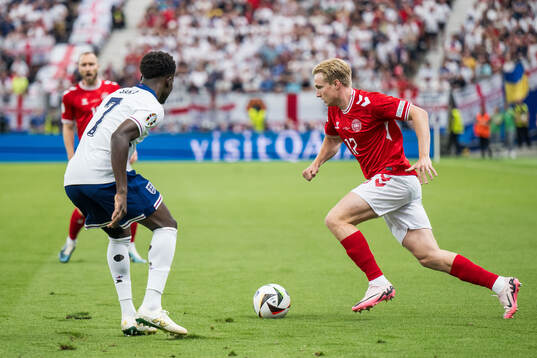 Bukayo Saka of England and Victor Kristiansen of Denmark