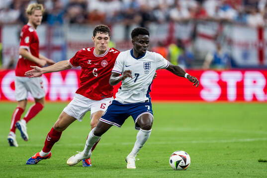 Andreas Kristiansen of Denmark and Bukayo Saka of England