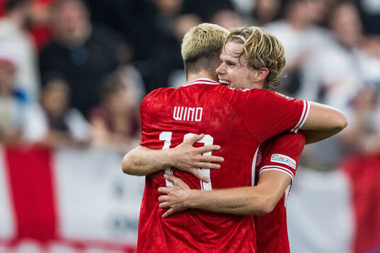 Morten Hjulmand and Jonas Wind of Denmark celebrate