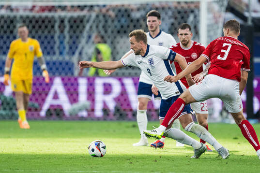 Harry Kane of England and Jannik Vestergaard of Denmark