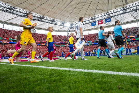 Goalkeeper Jordan Pickford and Harry Kane of England enter