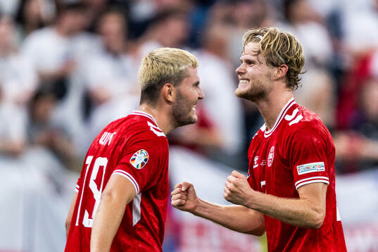 Jonas Wind next to Morten Hjulmand of Denmark who