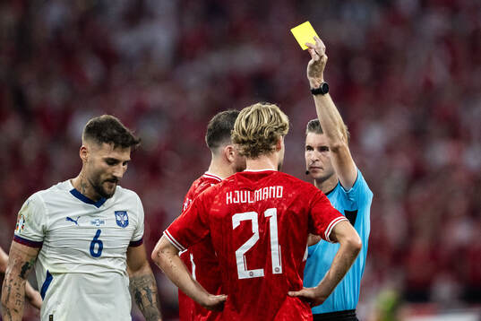 Morten Hjulmand of Denmark receives a yellow card from