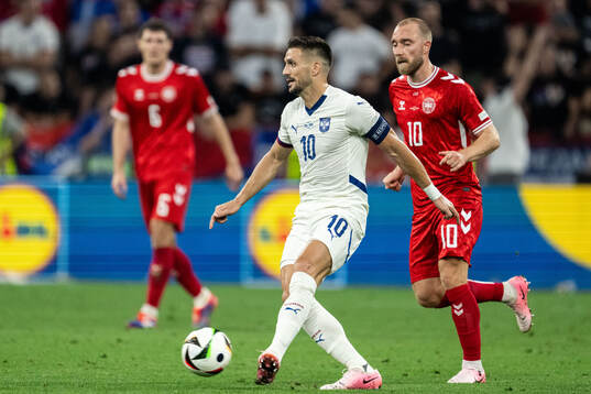 Dusan Tadic of Serbia and Christian Eriksen of Denmark