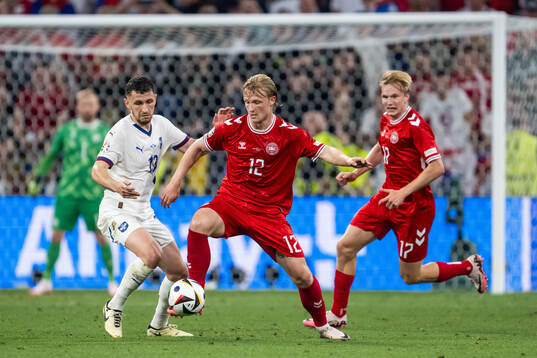 Milos Veljkovic of Serbia and Kasper Dolberg of Denmark