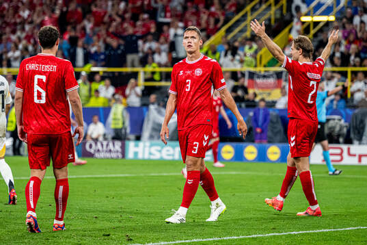 Jannik Vestergaard and Joachim Andersen of Denmark reacts