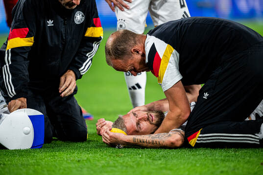 Robert Andrich of Germany with the medical team