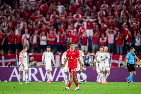 Alexander Bah of Denmark looks dejected