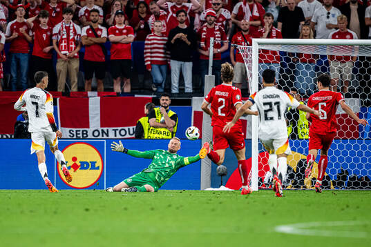Kai Havertz of Germany and goalkeeper Kasper Schmeichel of