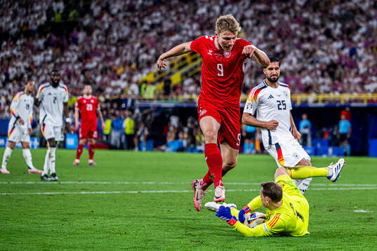 Rasmus Højlund of Denmark and Emre Can and goalkeeper