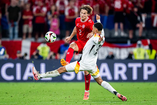 Joachim Andersen of Denmark and Jamal Musiala of Germany