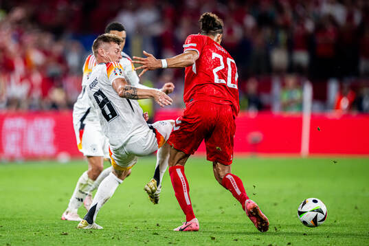 Toni Kroos of Germany and Yussuf Poulsen of Denmark