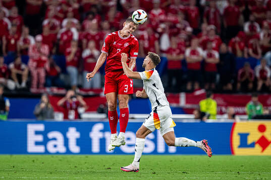 Jannik Vestergaard of Denmark and Niclas Fullkrug of Germany