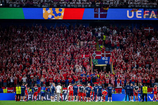 Players of Denmark together with their supporters