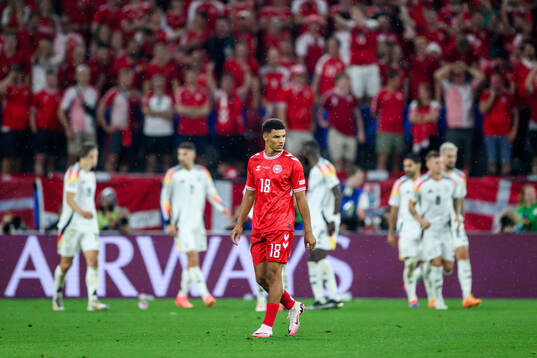 Alexander Bah of Denmark looks dejected