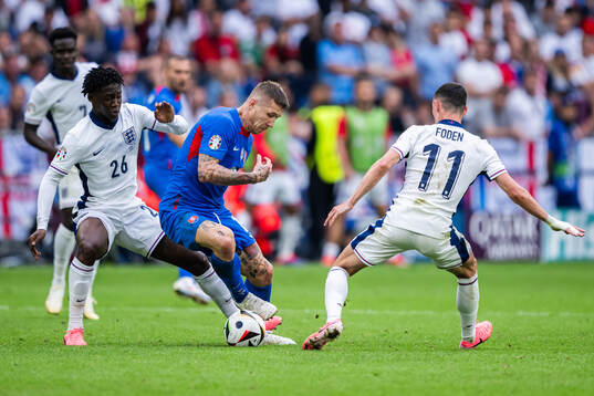 Juraj Kucka of Slovakia and Kobbie Mainoo and Phil Foden of
