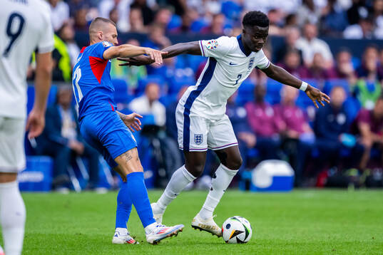Lukas Haraslin of Slovakia and Bukayo Saka of England