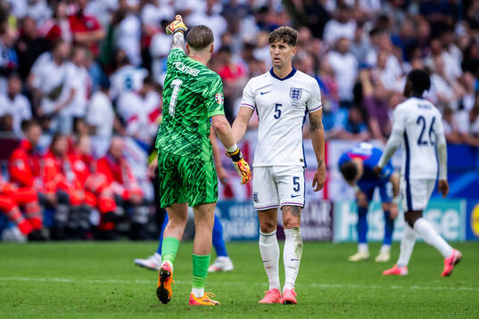 Goalkeeper Jordan Pickford and John Stones of England