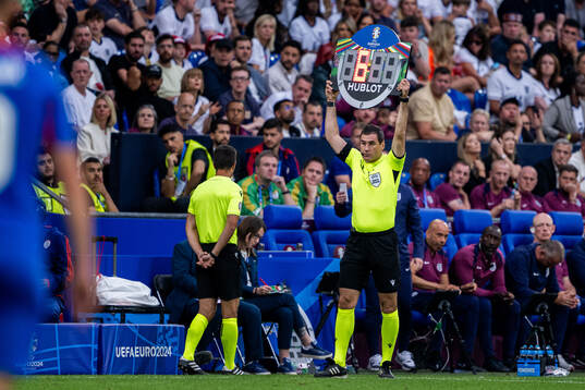 The assistant referee shows the added time