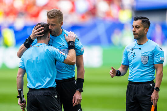 Referee Glenn Nyberg along with assistant referees Mahbod