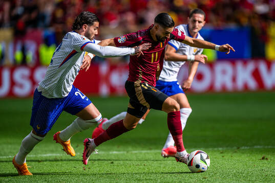 Theo Hernandez of France and Yannick Carrasco of Belgium