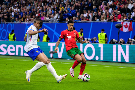 Kylian Mbappé of France and Joao Cancelo of Portugal