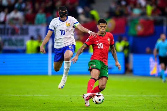 Kylian Mbappé of France and Joao Cancelo of Portugal