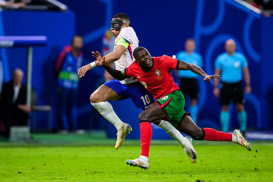 Kylian Mbappé of France and Nuno Mendes of Portugal
