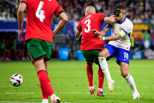 Pepe of Portugal and Kylian Mbappé of France