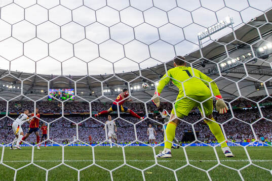 Mikel Merino of Spain scores 2-1 behind goalkeeper Manuel
