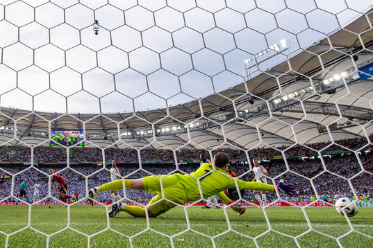 Daniel Olmo of Spain scores 1-1 behind goalkeeper Manuel