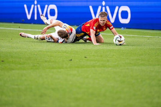 Joshua Kimmich of Germany and Daniel Olmo of Spain compete