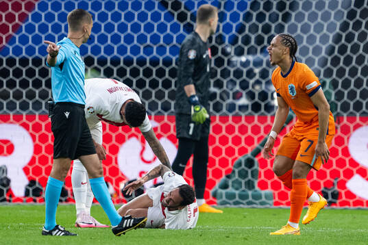 Xavi Simons of Netherlands and Hakan Calhanoglu of Turkey