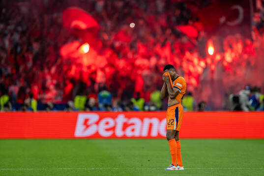 Denzel Dumfries of Netherlands looks dejected