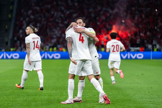 Samet Akaydin and Hakan Calhanoglu of Turkey celebrate