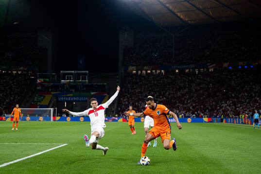 Mert Muldur of Turkey and Cody Gakpo of Netherlands