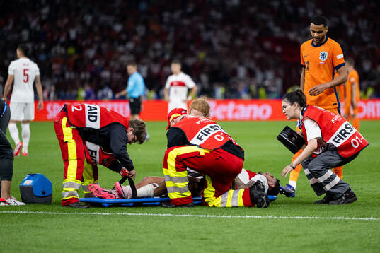 Samet Akaydin of Turkey is carried off the field