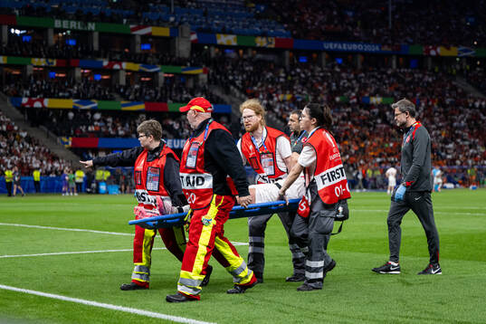 Samet Akaydin of Turkey is carried off the field