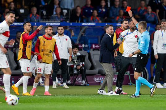 Referee Clement Turpin shows a red card